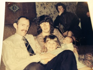 Three year old me with my mum, dad and very new baby brother.